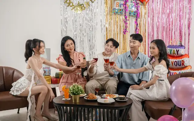 Friends celebrating with drinks at a nightclub table